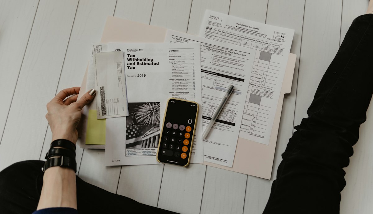 US tax forms with a calculator and pen